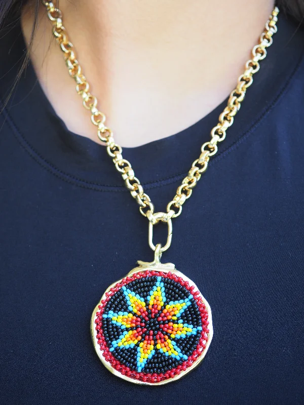 RED - BLACK BEADED ROSETTE ON  DISC ON GOLD FILLED OVAL CLASP